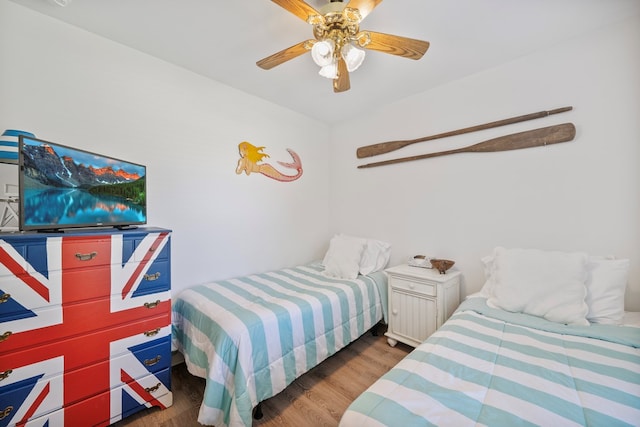 bedroom featuring a ceiling fan and wood finished floors