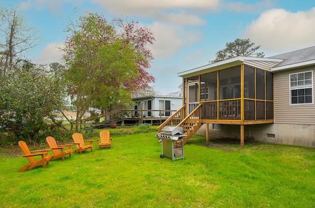 rear view of house featuring a yard, a sunroom, and crawl space