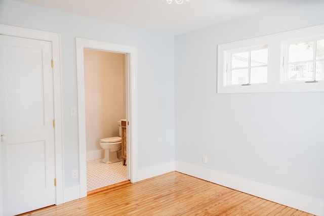 empty room with baseboards and light wood-style flooring