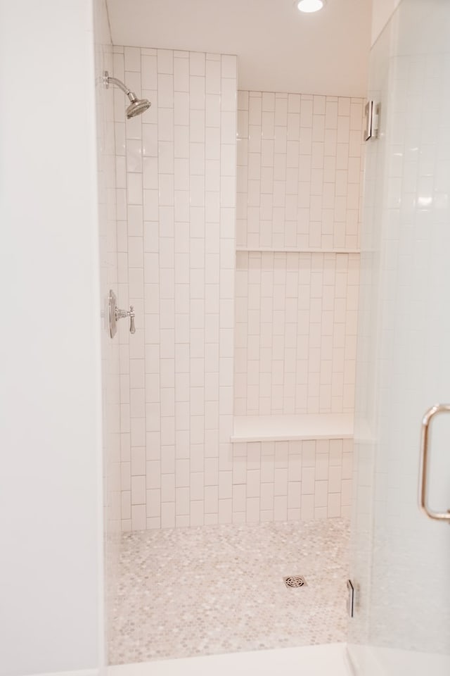 bathroom with a shower stall and recessed lighting