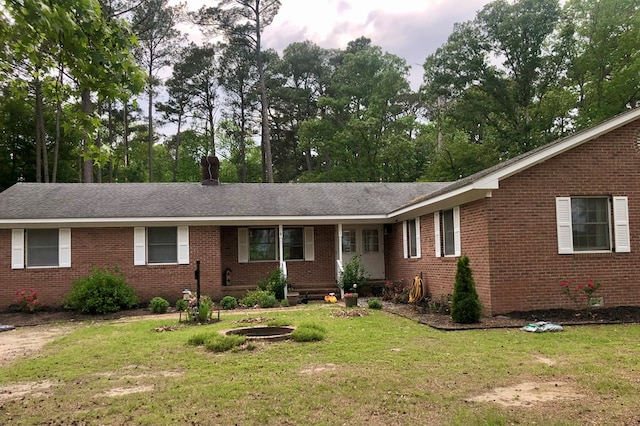 21020 Adams Rd, Greenbush, VA 23357 - single story home with brick siding, a front yard, and roof with shingles