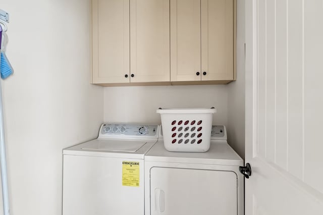 washroom with cabinet space and independent washer and dryer