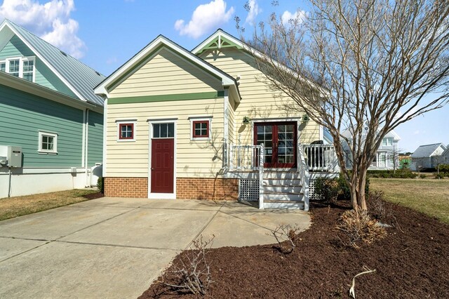 rear view of house featuring a deck