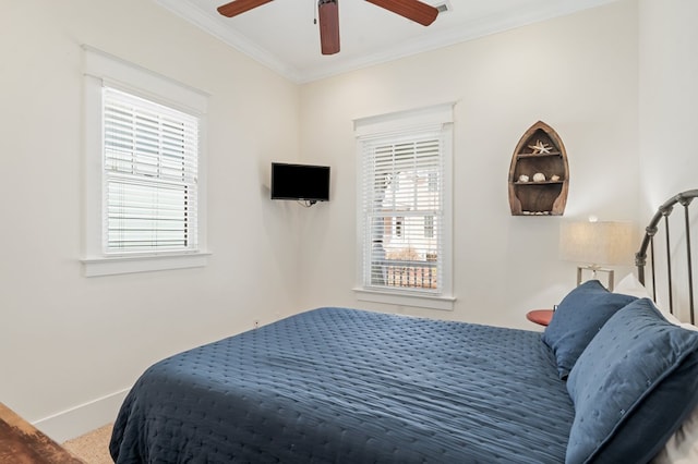 bedroom featuring baseboards, a ceiling fan, and crown molding