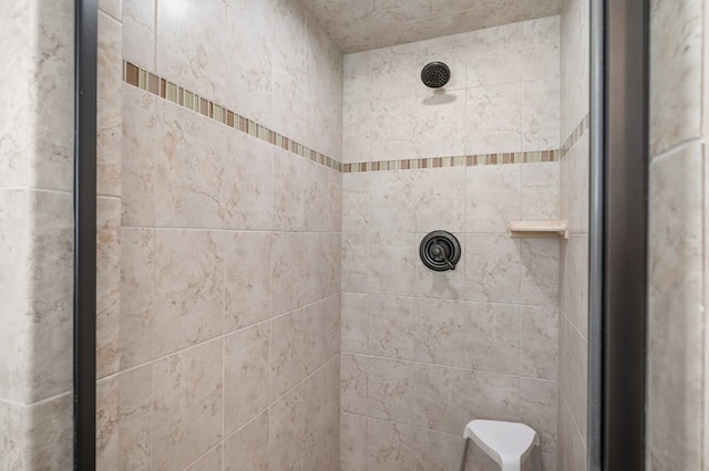 bathroom with a tile shower