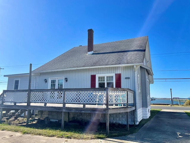 back of property with a wooden deck