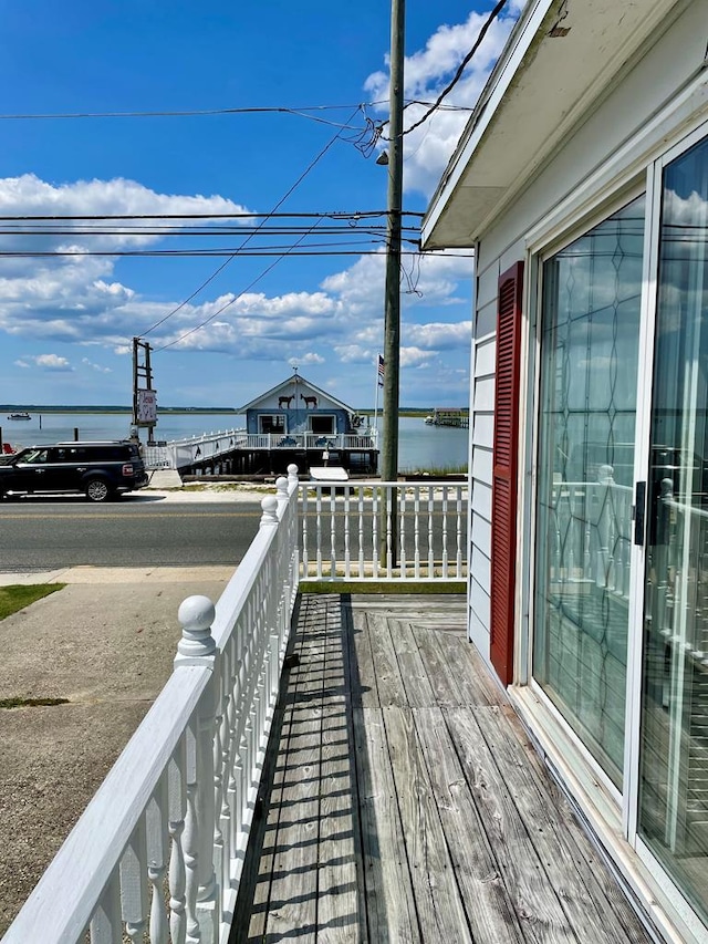 wooden deck featuring a water view