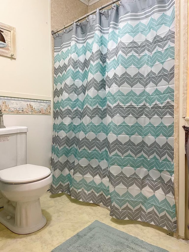 bathroom with toilet and curtained shower