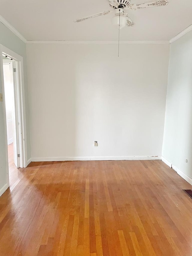 empty room with hardwood / wood-style flooring, ceiling fan, and crown molding