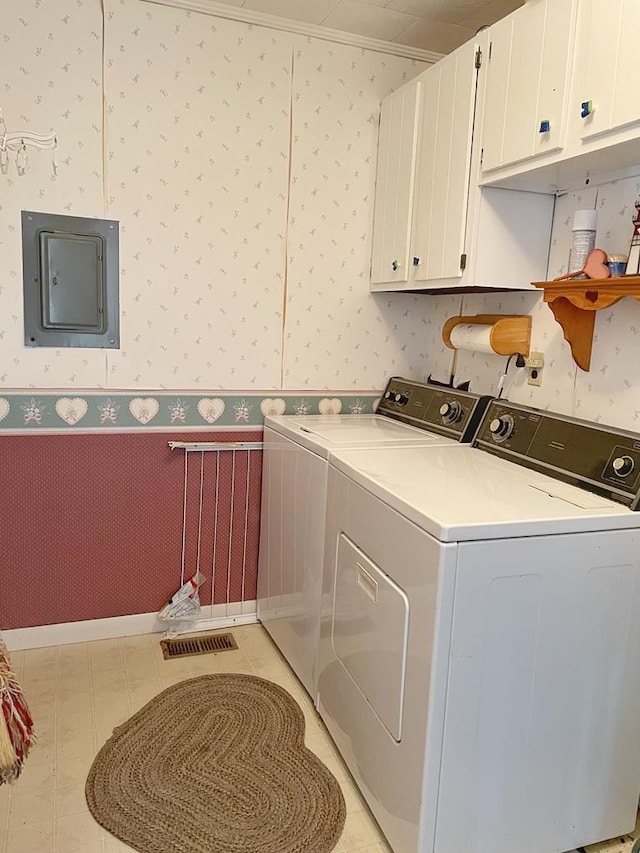 clothes washing area featuring cabinets, ornamental molding, light tile patterned floors, separate washer and dryer, and electric panel