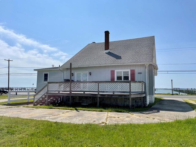 back of house with a lawn and a wooden deck