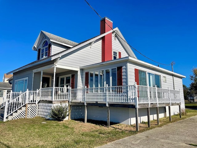 view of property exterior featuring a lawn and a porch