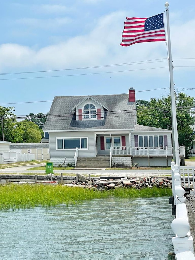 back of property with a water view