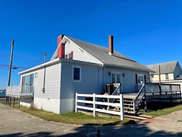 rear view of property with a wooden deck