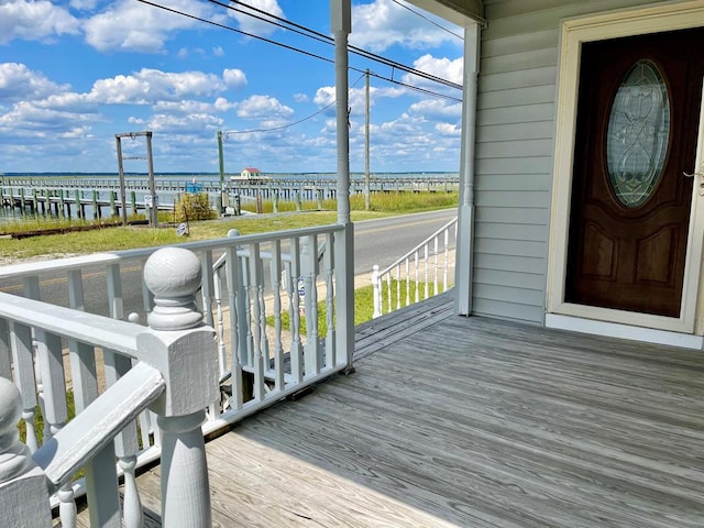 wooden terrace featuring a water view