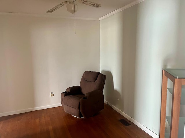 living area featuring dark hardwood / wood-style flooring, ceiling fan, and crown molding