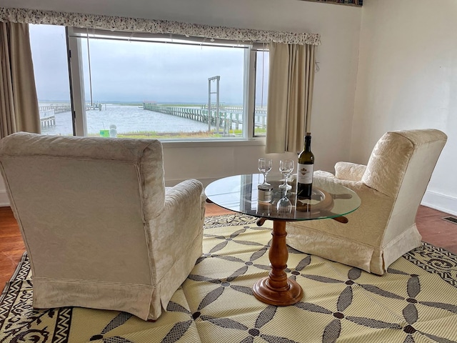 dining room featuring a water view and hardwood / wood-style flooring