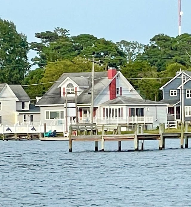 rear view of property with a water view