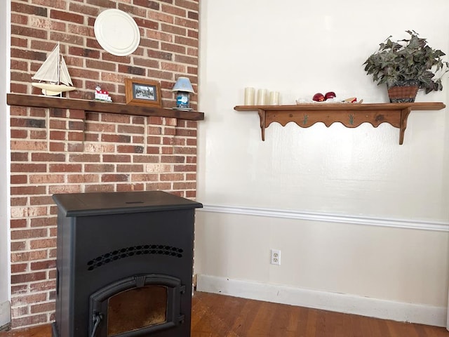 details featuring hardwood / wood-style floors and a wood stove