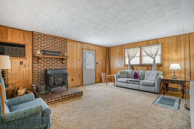carpeted living room with a wood stove, a wall mounted AC, and wooden walls