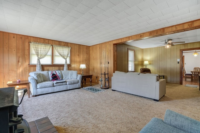 living room featuring carpet flooring, ceiling fan, and plenty of natural light