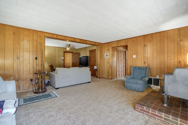 carpeted living room with ceiling fan
