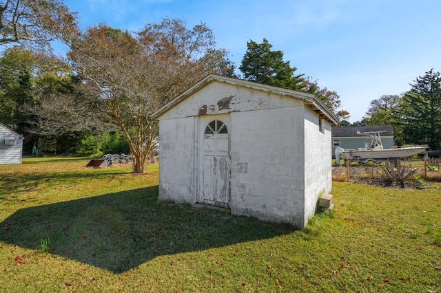 view of outbuilding featuring a yard
