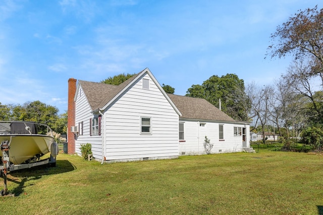 rear view of property with a yard