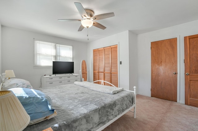 carpeted bedroom featuring two closets and ceiling fan