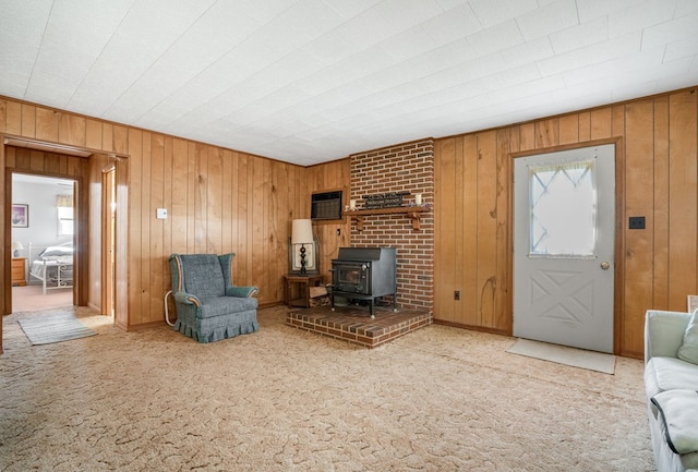 carpeted living room featuring a wood stove