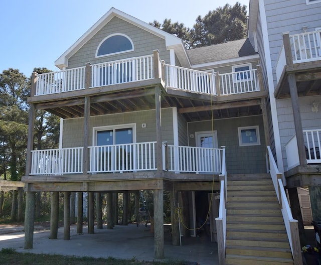 3365 Peaceful Ln, Chincoteague, VA 23336 - back of house featuring a carport, a porch, stairway, and a balcony