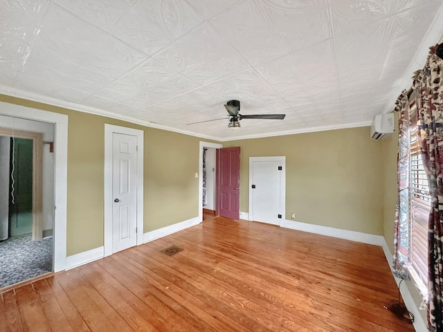 25539 Shoremain Dr, Bloxom, VA 23308 - empty room featuring hardwood / wood-style flooring, a wall mounted AC, a ceiling fan, baseboards, and ornamental molding
