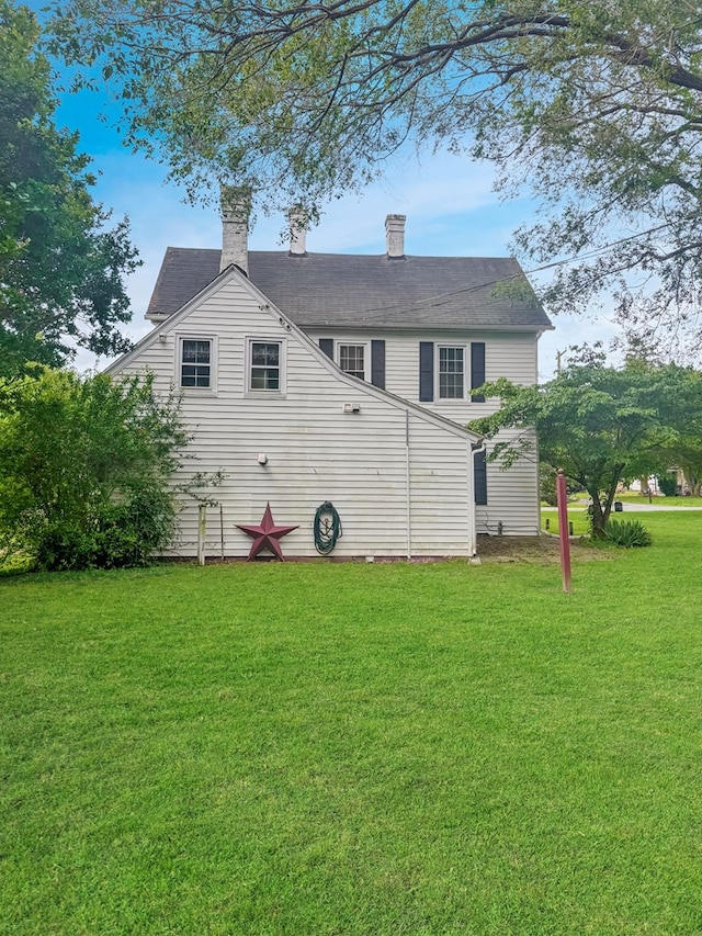 25539 Shoremain Dr, Bloxom, VA 23308 - rear view of house with a lawn and a chimney