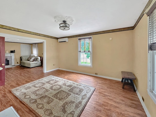 25539 Shoremain Dr, Bloxom, VA 23308 - living area featuring wood finished floors, a wall mounted AC, baseboards, and a fireplace