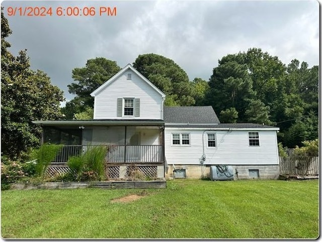 back of property featuring a lawn