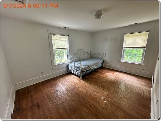 unfurnished bedroom featuring dark wood-type flooring