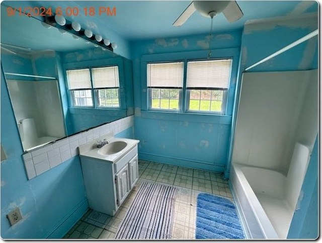 bathroom featuring vanity, shower / washtub combination, and ceiling fan