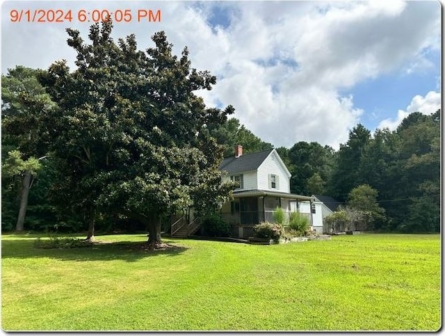 view of yard featuring a sunroom