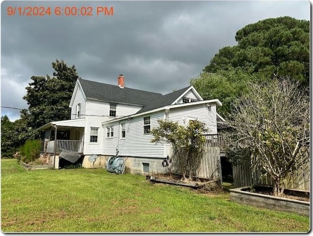 back of house featuring a yard