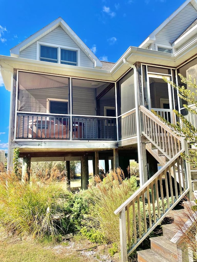 5108 Wildcat Ln, Chincoteague, VA 23336 - view of front facade featuring a sunroom and stairway