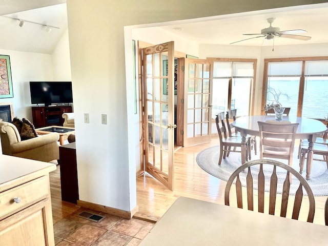 5108 Wildcat Ln, Chincoteague, VA 23336 - dining room with track lighting, a ceiling fan, french doors, and light wood-style flooring