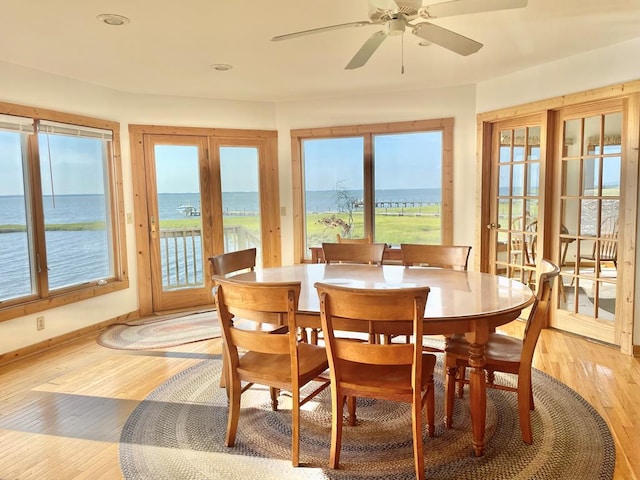5108 Wildcat Ln, Chincoteague, VA 23336 - dining area featuring a water view, light wood finished floors, recessed lighting, ceiling fan, and french doors