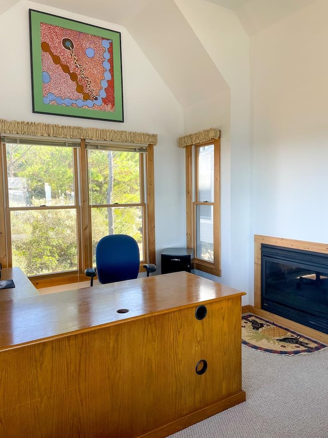 5108 Wildcat Ln, Chincoteague, VA 23336 - carpeted office space with a glass covered fireplace, vaulted ceiling, and healthy amount of natural light