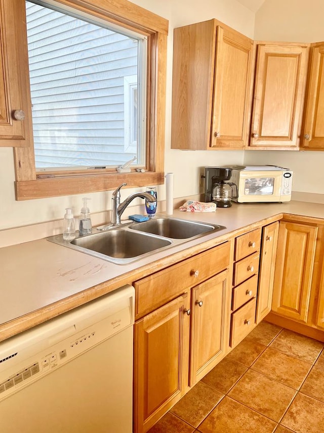 5108 Wildcat Ln, Chincoteague, VA 23336 - kitchen with white dishwasher, light countertops, light tile patterned floors, and light brown cabinets