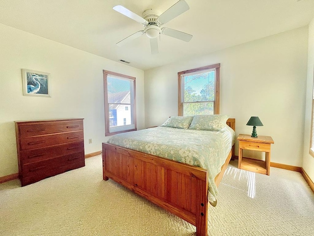 5108 Wildcat Ln, Chincoteague, VA 23336 - bedroom featuring light colored carpet, multiple windows, and ceiling fan