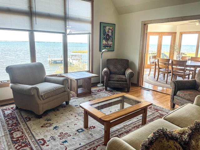 5108 Wildcat Ln, Chincoteague, VA 23336 - living area featuring wood finished floors, vaulted ceiling, and a water view