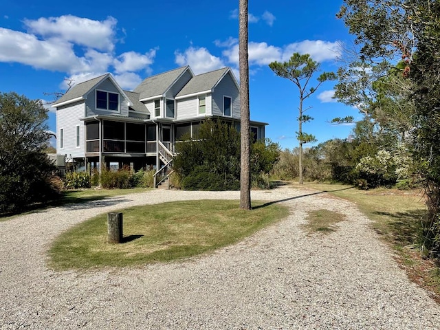 5108 Wildcat Ln, Chincoteague, VA 23336 - view of front of home with a sunroom, curved driveway, and a front yard