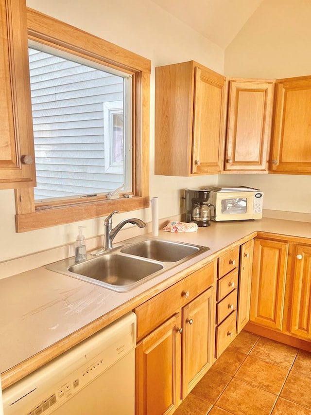 5108 Wildcat Ln, Chincoteague, VA 23336 - kitchen with white appliances, light countertops, light tile patterned floors, vaulted ceiling, and plenty of natural light
