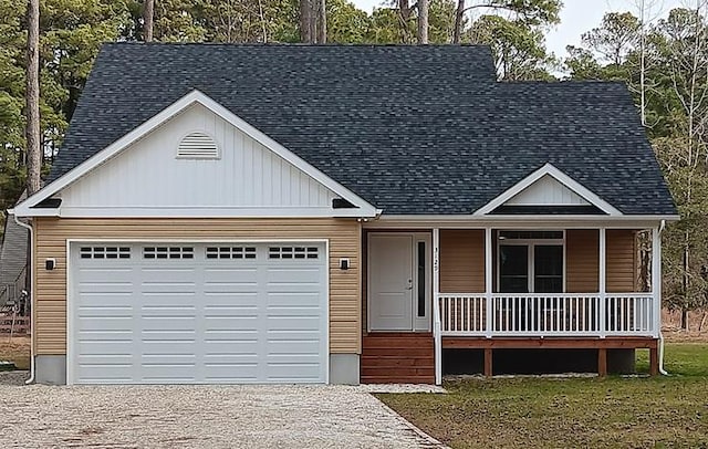 view of front of property with a porch, an attached garage, driveway, and roof with shingles