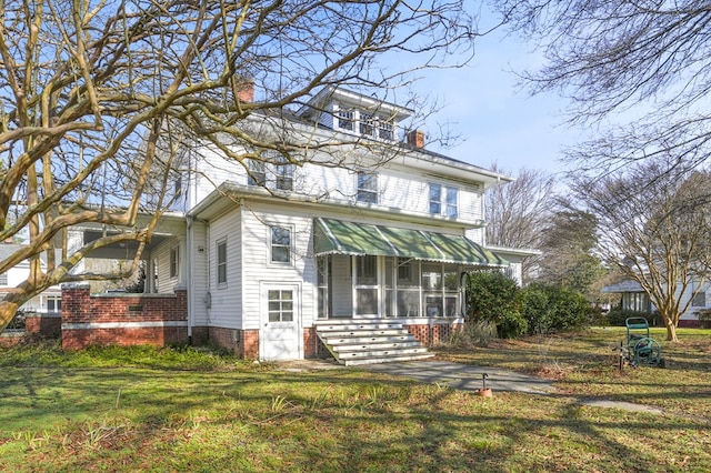 view of front of house with a chimney and a front yard